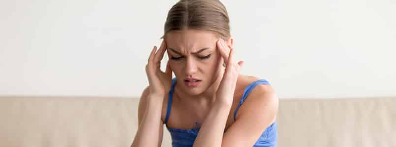 Woman suffering from phentermine side effects, including headache