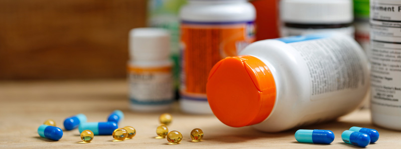 assorted pills and bottles on a counter top