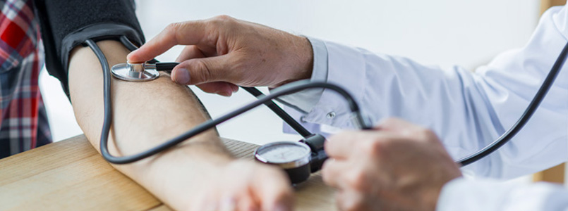 doctor taking a man's blood pressure