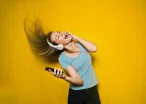 woman dancing with headphones on