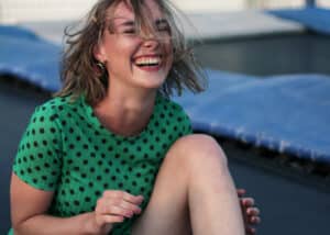 woman laughing on trampoline